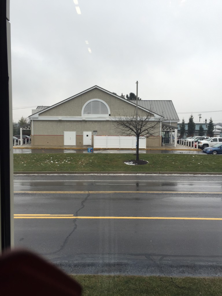 This WaWa represents really awful design.  It's the boilerplate generic WaWa. But making it worse is what everyone drives past is the side of the building. Recently the township had to make the store enclose dumpsters with that vinyl fence. 